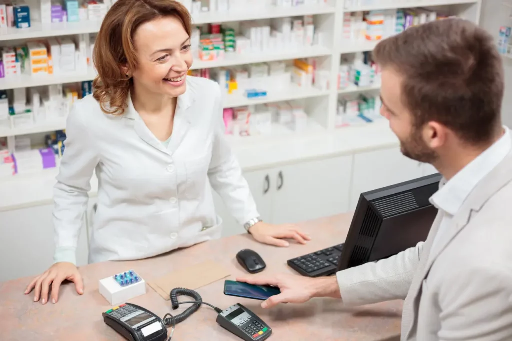 male trying to buy medication from female pharmacist